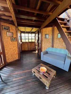 a living room with a couch and a coffee table at Ikuna Luxury Glamping 1h from Medellin with Private Jacuzzi in San Vicente