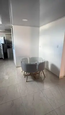 a table and chairs in a room with a kitchen at torre linares 1 in Manizales