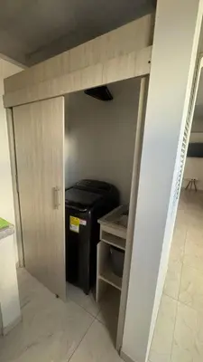 a small room with a door leading into a room with a stove at torre linares 1 in Manizales