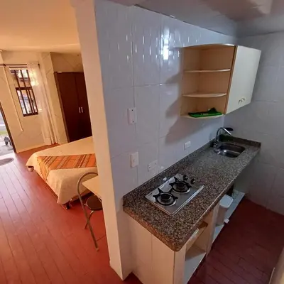 a kitchen with a stove and a sink in a room at El Mejor Aparta Estudio De La Ciudad in Manizales