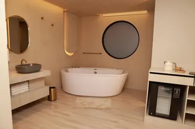 a bathroom with a tub and a sink and a mirror at VPV Suites & Casino in Medellín