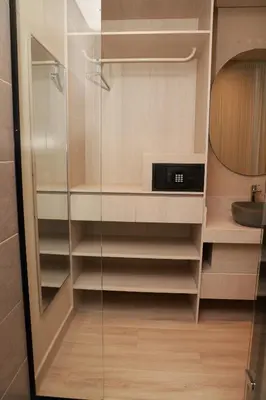 a glass closet with a sink and a clock in it at VPV Suites & Casino in Medellín
