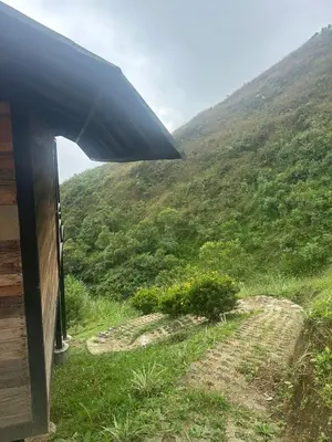 a view from the outside of a house looking at a mountain at SKY Glamping San Félix in Bello