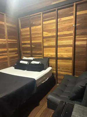 a bedroom with a bed and a couch at SKY Glamping San Félix in Bello