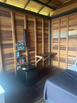 a room with a bed and a desk with a television at SKY Glamping San Félix in Bello