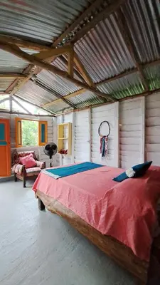 a large bedroom with a large bed in a building at Rocas del Rio Ecohotel in Mutatá