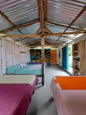 a bedroom with two beds in a house at Rocas del Rio Ecohotel in Mutatá
