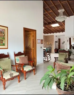 a living room with chairs and a table at Fami Hotel Luz de Luna in Jardin