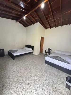 a bedroom with two beds and a wooden ceiling at Hospedaje Doña Blanca in Concepción
