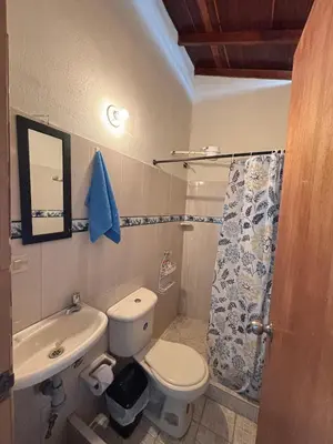 a small bathroom with a toilet and a sink at Hospedaje Doña Blanca in Concepción