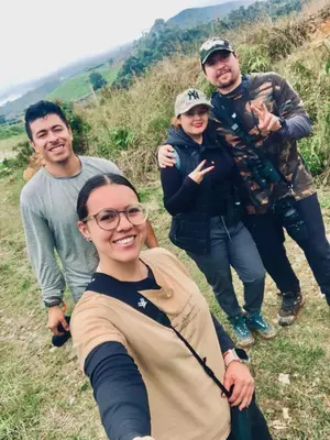a group of people posing for a picture on a hill at Maderalia in El Salvador