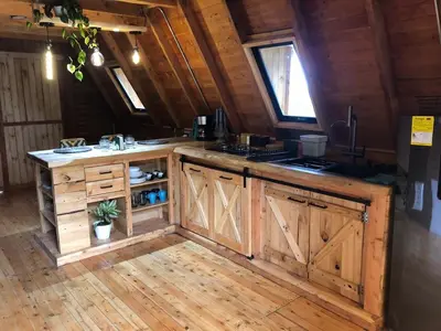a kitchen with wooden cabinets and a counter top at Maderalia in El Salvador