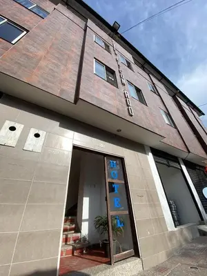 a building with a glass door in front of it at Hotel el CONDADO in Itagüí