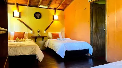 a room with two beds in a room at El Santuario Retreat in Guatapé