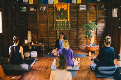 a group of people sitting in a room in a yoga class at El Santuario Retreat in Guatapé