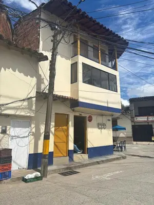 a white and blue building on the side of a street at Hospedaje Doña Blanca 2 in Concepción