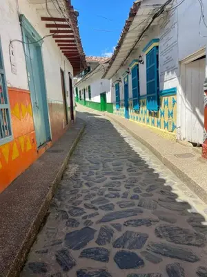 a cobblestone street in an alley with colorful buildings at Hospedaje Doña Blanca 2 in Concepción