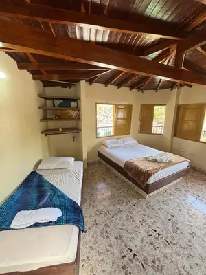 two beds in a room with wooden ceilings at Hospedaje Doña Blanca 2 in Concepción