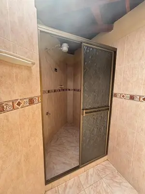a shower with a glass door in a bathroom at Hospedaje Doña Blanca 2 in Concepción