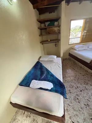 a bedroom with two beds in a room at Hospedaje Doña Blanca 2 in Concepción
