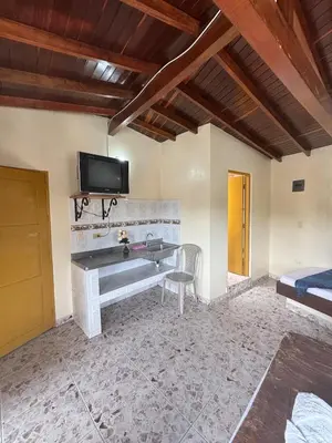 a living room with a fireplace and a tv on the wall at Hospedaje Doña Blanca 2 in Concepción