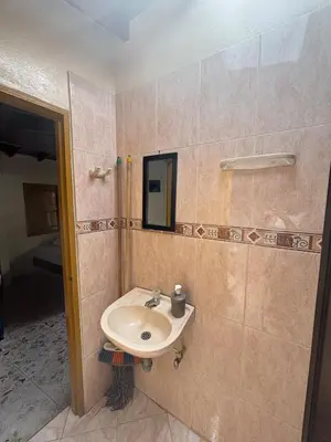 a bathroom with a sink and a mirror at Hospedaje Doña Blanca 2 in Concepción