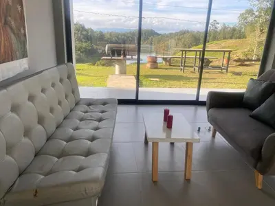 a living room with a couch and a coffee table at Nakawe Guatape in Guatapé