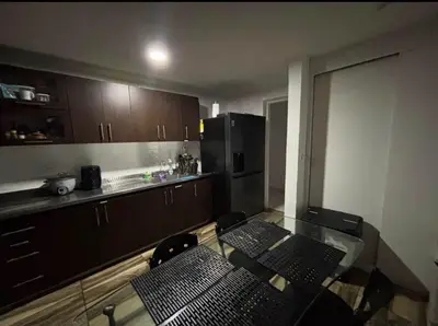 a kitchen with a glass table and a counter top at Happy house in Medellín