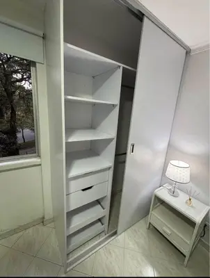 a walk in closet with a table and a lamp at Happy house in Medellín