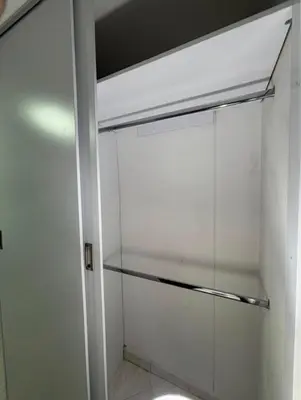 a walk in closet with a glass door at Happy house in Medellín