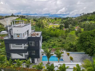 an aerial view of a building with a swimming pool at The Palms Hotel in Estación El Salto