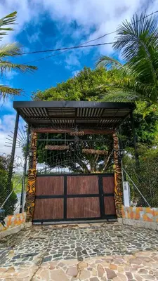 a wooden garage door with a wooden gate at The Palms Hotel in Estación El Salto