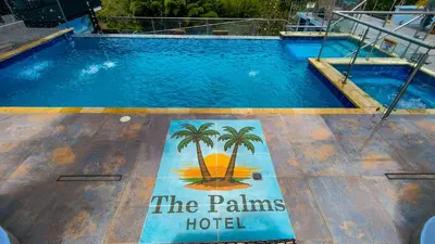 a swimming pool with a hotel sign on the floor at The Palms Hotel in Estación El Salto