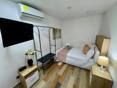 a small bedroom with a bed and a room with a heater at Bravas Medallo in Medellín