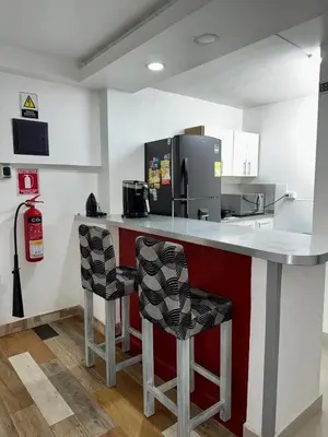 a kitchen with a counter with two bar stools at Bravas Medallo in Medellín