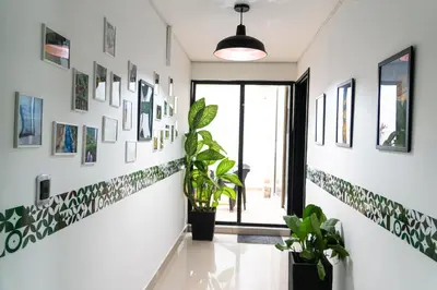 a hallway with plants and pictures on the walls at Bravas Medallo in Medellín