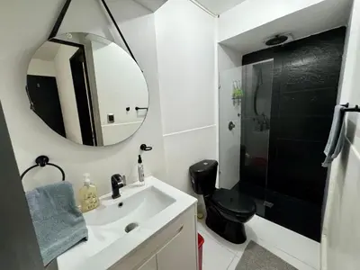 a bathroom with a sink and a mirror and a shower at Bravas Medallo in Medellín