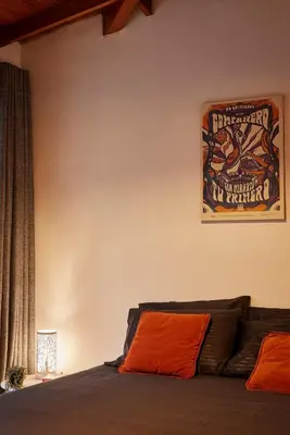 a bedroom with a bed with a poster on the wall at El Poblado Medellin Luxury 5BR Jacuzzi AC in Medellín