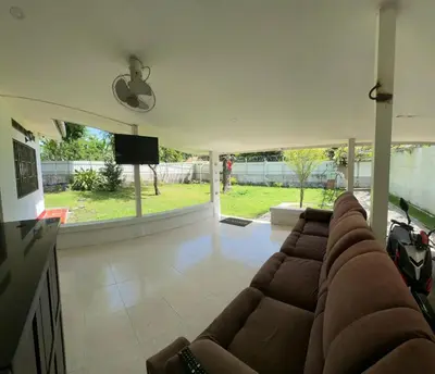 a living room with a couch and a flat screen tv at villa juliana in Mariquita