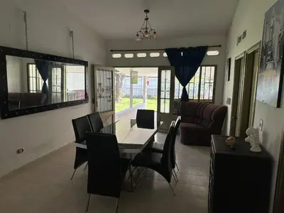 a dining room and living room with a table and chairs at villa juliana in Mariquita