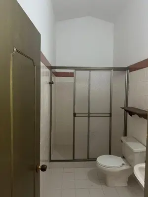 a bathroom with a shower and a toilet and a sink at villa juliana in Mariquita