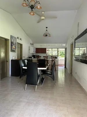 a dining room and kitchen with a table and chairs at villa juliana in Mariquita