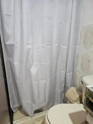 a bathroom with a white shower curtain and a toilet at Aparta estudio en Concepción in Concepción