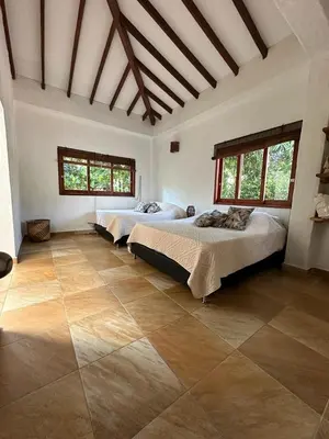a large room with two beds in it at Finca La Verbena in San Jerónimo