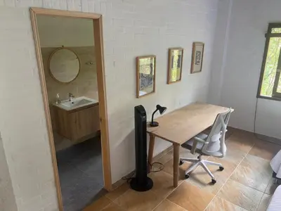 a room with a desk with a television and a sink at Finca La Verbena in San Jerónimo