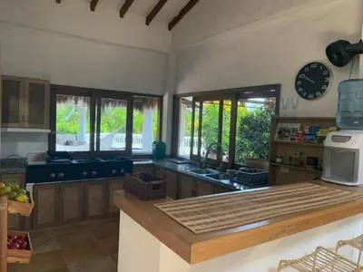 a kitchen with a counter top and some windows at Finca La Verbena in San Jerónimo