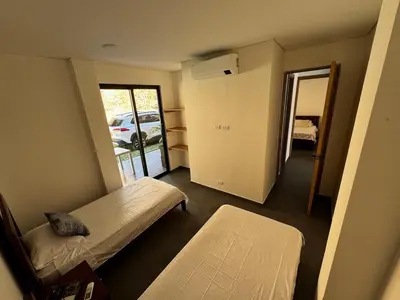 a room with two beds and a door to a car at Luxury estate in San Jerónimo with infinity pool in San Jerónimo