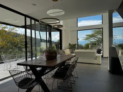 a living room with a wooden table and chairs at Luxury estate in San Jerónimo with infinity pool in San Jerónimo