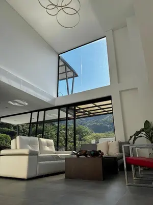 a living room with a white couch and a large window at Luxury estate in San Jerónimo with infinity pool in San Jerónimo