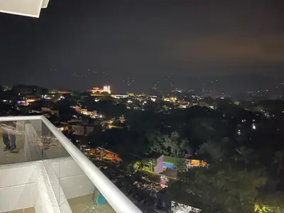 a view of a city at night from a building at HERMOSO APARTAMENTO CITADELA DI SOLE EN SANTAFE DE ANTIOQUIa in Santa Fe de Antioquia
